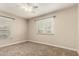 A serene bedroom with two windows, a ceiling fan, and neutral tones creating a cozy retreat at 840 E 2Nd St, Mesa, AZ 85203