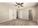 Spacious bedroom with a ceiling fan, closet, and ensuite bathroom entrance at 840 E 2Nd St, Mesa, AZ 85203