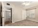 A spacious bedroom with natural light, a closet, ceiling fan and a glimpse into an adjacent room at 840 E 2Nd St, Mesa, AZ 85203