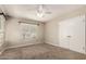 An inviting bedroom with neutral carpet, white trim, ceiling fan and a window with blinds at 840 E 2Nd St, Mesa, AZ 85203