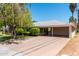 Street view of a single-story home featuring a carport, with landscaping and mature trees at 840 E 2Nd St, Mesa, AZ 85203