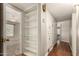 An organized hallway with built-in shelving and storage cabinets for convenient accessibility and storage at 840 E 2Nd St, Mesa, AZ 85203