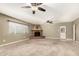 Spacious living area with a unique brick fireplace and ceiling fans for added comfort at 840 E 2Nd St, Mesa, AZ 85203