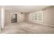 Spacious living room with neutral carpet, trim, and shutters, offering ample natural light at 840 E 2Nd St, Mesa, AZ 85203