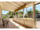 Screened-in patio area offers a relaxing space with views of the backyard and comfortable seating at 840 E 2Nd St, Mesa, AZ 85203