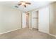 Bedroom with carpet, ceiling fan, closet and door to hall at 8503 W Coyote Dr, Peoria, AZ 85383
