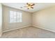 Carpeted bedroom with a ceiling fan and a window providing natural light at 8503 W Coyote Dr, Peoria, AZ 85383