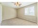 Comfortable carpeted bedroom with neutral walls, ceiling fan and window with blinds at 8503 W Coyote Dr, Peoria, AZ 85383