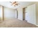 Inviting carpeted bedroom featuring a ceiling fan and closet at 8503 W Coyote Dr, Peoria, AZ 85383