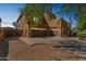 Two-story stucco home with brown garage doors, a low-maintenance front yard, and desert landscaping at 8503 W Coyote Dr, Peoria, AZ 85383