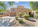 Southwest-style home showcasing desert landscaping, a spacious driveway, and a two-car garage at 8503 W Coyote Dr, Peoria, AZ 85383