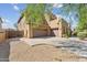 Two-story stucco home with brown garage doors, a low-maintenance front yard, and desert landscaping at 8503 W Coyote Dr, Peoria, AZ 85383