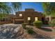 Southwest-style home showcasing desert landscaping, a spacious driveway, and a two-car garage at 8503 W Coyote Dr, Peoria, AZ 85383