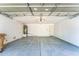 A well-lit two car garage with concrete floors and storage areas at 8503 W Coyote Dr, Peoria, AZ 85383