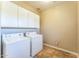 Laundry room with tile flooring, washer, dryer and cabinets at 8503 W Coyote Dr, Peoria, AZ 85383