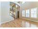 Spacious living room featuring hardwood floors, large windows with white shutters, and a staircase at 8503 W Coyote Dr, Peoria, AZ 85383