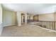 Second-floor loft featuring carpeted floors, neutral walls, and a decorative railing at 8503 W Coyote Dr, Peoria, AZ 85383