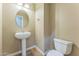 Cozy powder room with a pedestal sink, tile flooring, and a convenient toilet at 8503 W Coyote Dr, Peoria, AZ 85383