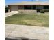 Charming single-story home showcasing a brick facade, well-maintained lawn, and attached two-car garage at 10025 W Shasta W Dr, Sun City, AZ 85351
