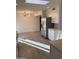 Spacious kitchen featuring stainless steel refrigerator, white cabinets, and wood-look tile flooring at 10025 W Shasta W Dr, Sun City, AZ 85351