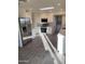 Bright kitchen featuring stainless steel appliances, white cabinets, tiled backsplash, and wood-look tile flooring at 10025 W Shasta W Dr, Sun City, AZ 85351