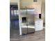 Modern kitchen featuring stainless steel refrigerator, white cabinets, and wood-look tile flooring throughout at 10025 W Shasta W Dr, Sun City, AZ 85351