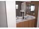 Bathroom featuring a double vanity with wood cabinets, mirror, and flowers at 1015 S Val Vista Dr # 8, Mesa, AZ 85204