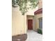 Inviting front entrance features a red door, covered walkway, and desert landscaping at 1015 S Val Vista Dr # 8, Mesa, AZ 85204