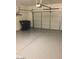 View of garage space features epoxy flooring and garage door with automatic opener at 1015 S Val Vista Dr # 8, Mesa, AZ 85204