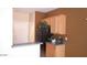 Kitchen area with black refrigerator, bar top, and light wood cabinetry at 1015 S Val Vista Dr # 8, Mesa, AZ 85204