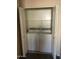 Laundry room with stacked white washer and dryer behind an open closet at 1015 S Val Vista Dr # 8, Mesa, AZ 85204