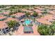 Community pool and clubhouse nestled amongst homes with red tiled roofs at 11375 E Sahuaro Dr # 1008, Scottsdale, AZ 85259