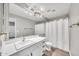 Clean bathroom showcasing a vanity with a white countertop, modern fixtures, and a shower with a curtain at 11375 E Sahuaro Dr # 1008, Scottsdale, AZ 85259