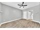 Spacious bedroom with wood-look tile floors, ceiling fan, and access to a walk-in closet and ensuite bathroom at 11375 E Sahuaro Dr # 1008, Scottsdale, AZ 85259