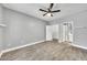 Spacious bedroom with wood-look tile floors, ceiling fan, and access to a walk-in closet and ensuite bathroom at 11375 E Sahuaro Dr # 1008, Scottsdale, AZ 85259