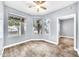 Bright bedroom featuring wood-look tile floors, a ceiling fan, and sunlit windows with views of the outdoors at 11375 E Sahuaro Dr # 1008, Scottsdale, AZ 85259