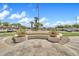 Community fountain with seating surrounded by lush, well-maintained landscaping at 11375 E Sahuaro Dr # 1008, Scottsdale, AZ 85259