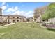 Community lawn area with desert landscaping, seating area, and apartment buildings at 11375 E Sahuaro Dr # 1008, Scottsdale, AZ 85259