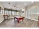 Well lit game room with a pool table, ceiling fan, and chairs at a bar at 11375 E Sahuaro Dr # 1008, Scottsdale, AZ 85259