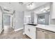 The kitchen has quartz countertops, stainless steel appliances, and wood look tile flooring at 11375 E Sahuaro Dr # 1008, Scottsdale, AZ 85259