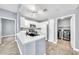 Open kitchen features white cabinets, quartz countertops, stainless steel appliances and adjacent laundry room at 11375 E Sahuaro Dr # 1008, Scottsdale, AZ 85259