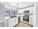Bright updated kitchen with white cabinets, quartz countertops, stainless appliances and a view from the large window at 11375 E Sahuaro Dr # 1008, Scottsdale, AZ 85259