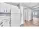 Bright kitchen features white cabinets, quartz countertops, stainless appliances and wood-look tile flooring at 11375 E Sahuaro Dr # 1008, Scottsdale, AZ 85259