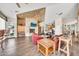 Open living room with a stone fireplace, TV, and kitchen bar seating at 11375 E Sahuaro Dr # 1008, Scottsdale, AZ 85259