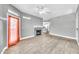 Spacious living room featuring a fireplace, wood-look tile flooring and modern ceiling fan at 11375 E Sahuaro Dr # 1008, Scottsdale, AZ 85259