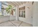 Private outdoor patio area with a painted wall and a view of a large palm tree at 11375 E Sahuaro Dr # 1008, Scottsdale, AZ 85259