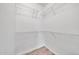 Walk-in closet with adjustable wire shelving and wood-look tile floors, optimizing storage space at 11375 E Sahuaro Dr # 1008, Scottsdale, AZ 85259