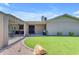 Grassy backyard with a covered patio area and a well-kept lawn offering a serene outdoor retreat at 12029 N 44Th Dr, Glendale, AZ 85304