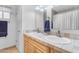 Bright bathroom featuring double sinks, tiled countertops, and classic finishes at 12029 N 44Th Dr, Glendale, AZ 85304
