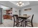 Bright dining room featuring a dark wood table with seating for four, tiled floors, and a stylish light fixture at 12029 N 44Th Dr, Glendale, AZ 85304